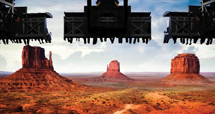 Three flight ride seats soar over the desert imagery.