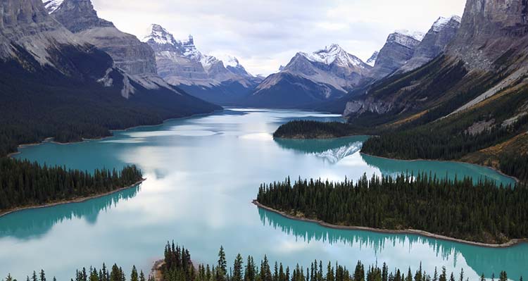 A mountain vista with lake with forest shoreline