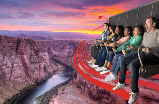 Riders over a canyon with a pink sky.